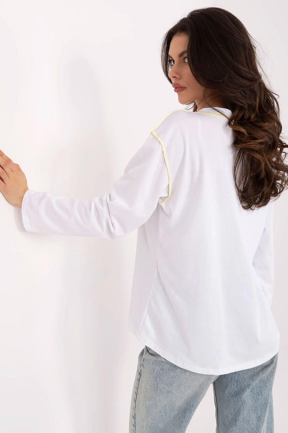 Women's white blouse with yellow trim, long sleeves and round neckline