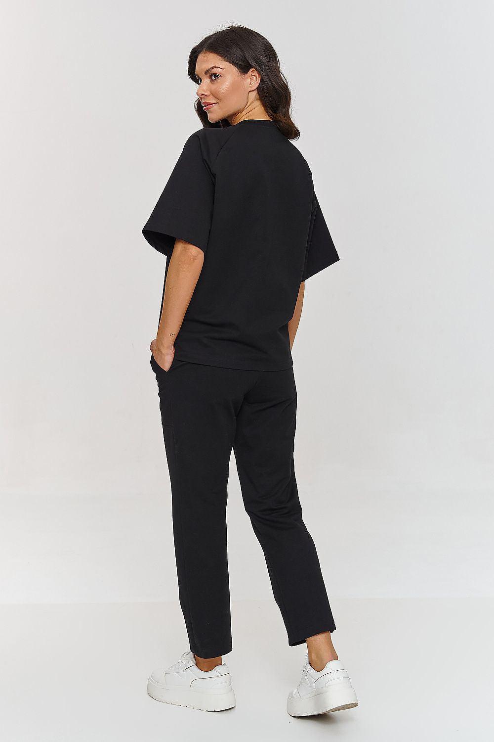 Black two-piece set viewed from back: short-sleeve top and tapered jogger pants