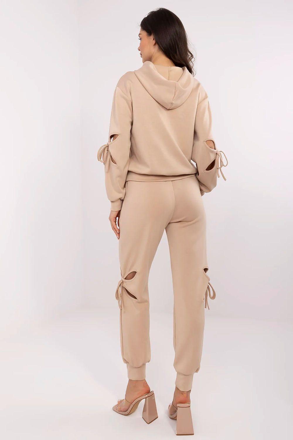 Beige tracksuit set, rear view; hooded sweatshirt and jogger pants with tied details.