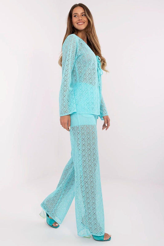 Turquoise openwork tie-front top and high-waist flared pants, full view