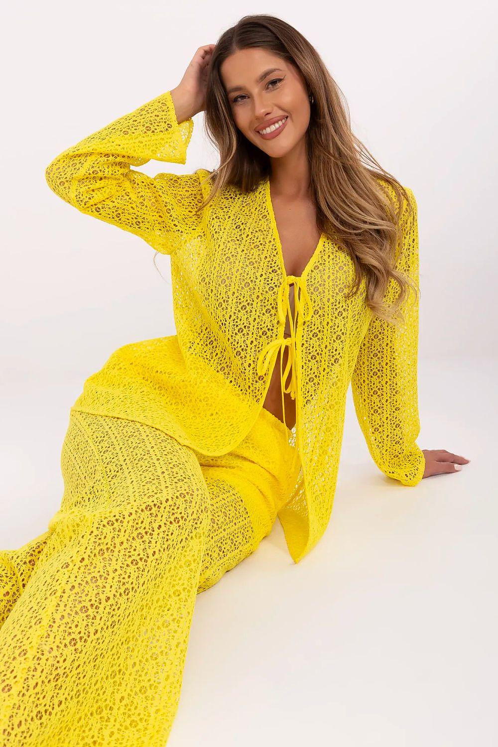 Yellow openwork set close-up: tie-front top with matching flared pants
