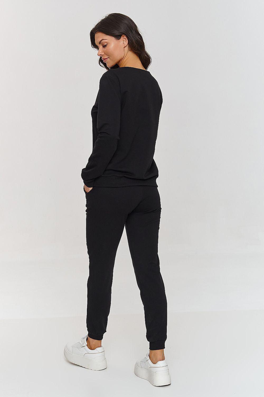 Makadamia black tracksuit set, side view with V-neck sweatshirt and tapered jogger pants