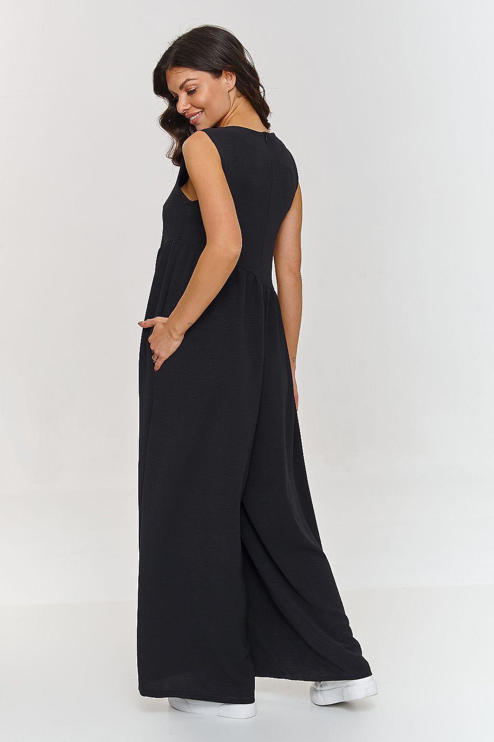 Black sleeveless maxi dress, side view, with gathered waist and long skirt