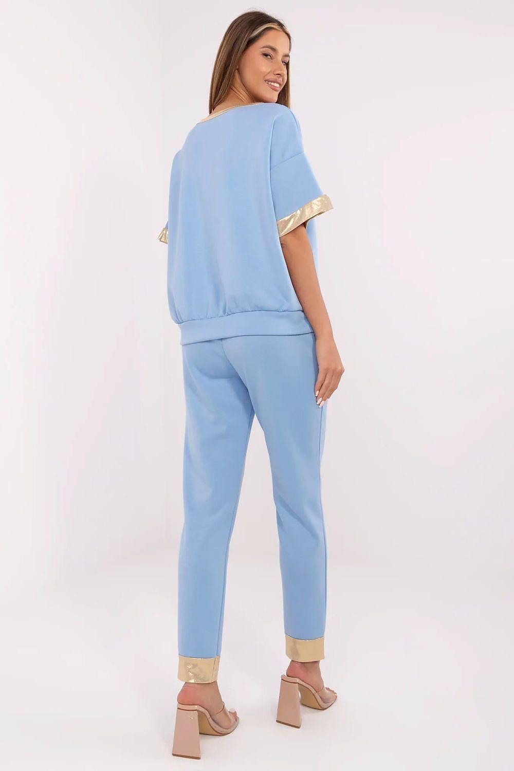Light blue two-piece tracksuit set with short-sleeve top and slim pants, gold-trim accents