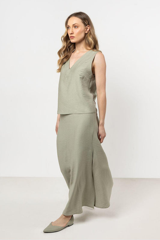 Sage green sleeveless V-neck blouse with fitted waist and side drape