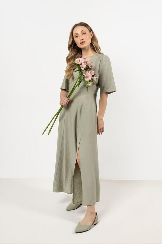Green V-neck day dress with short sleeves, side slit, and waist seam detail