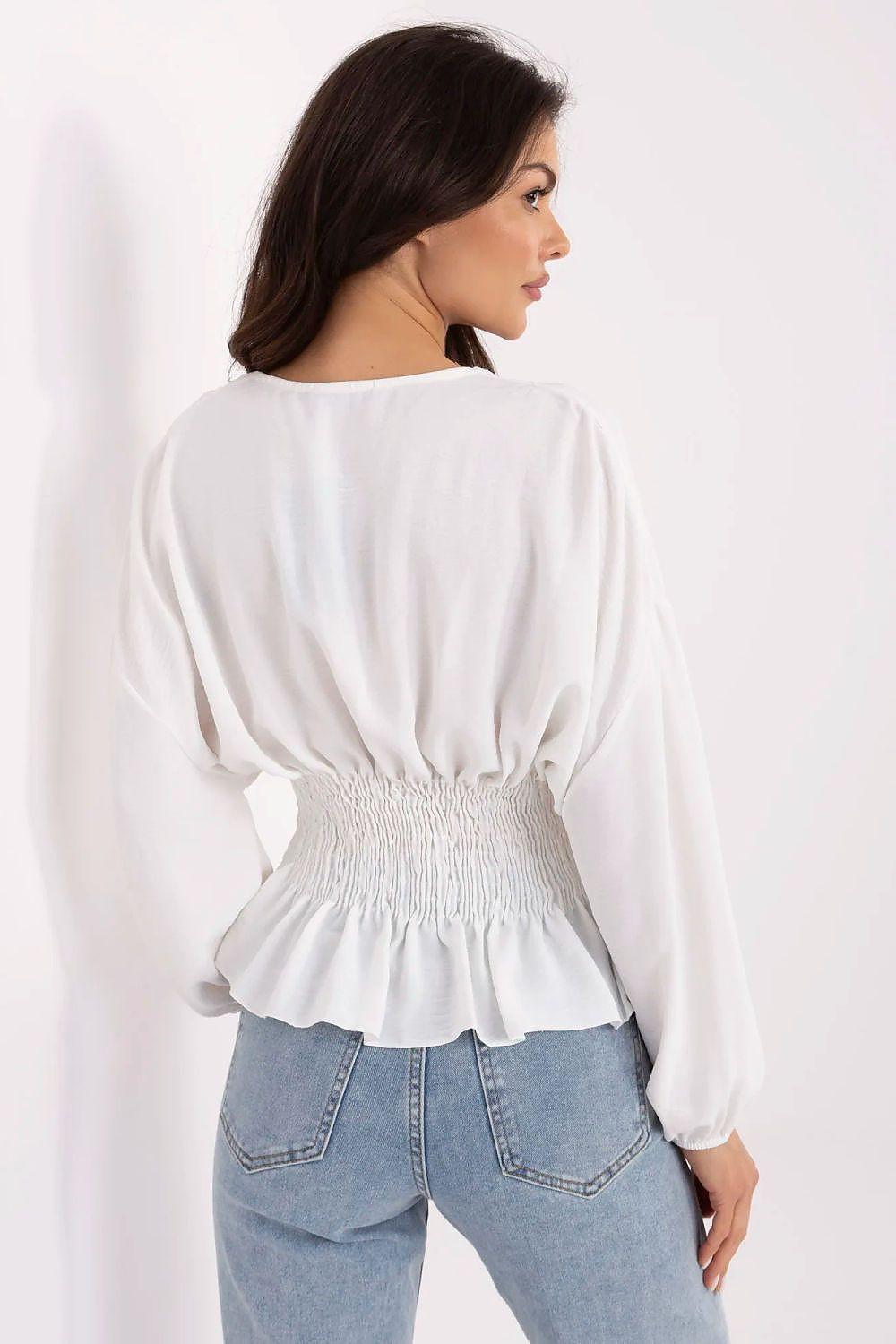 White blouse back view with smocked waist seam and peplum ruffle hem.