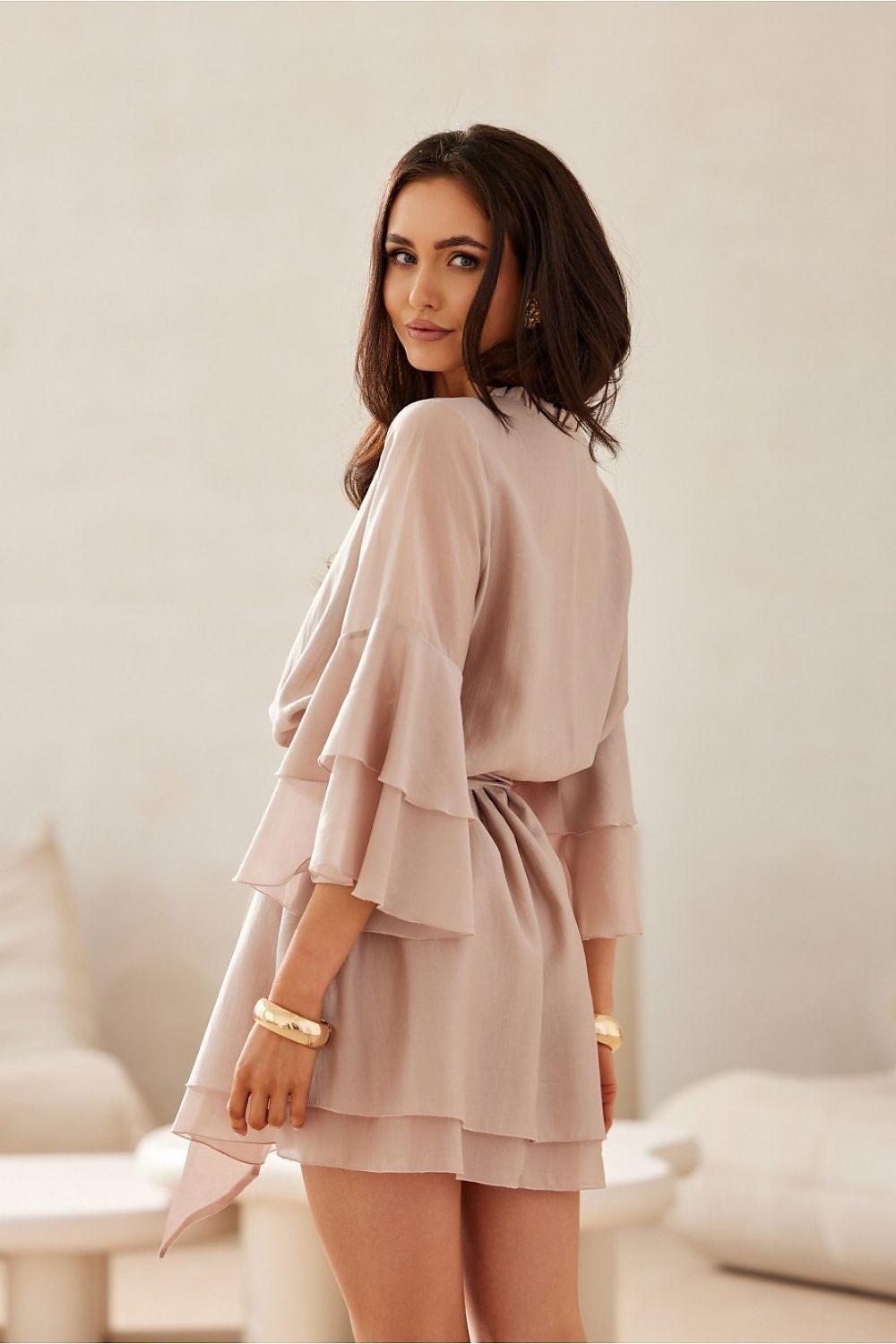 Beige cocktail dress with tiered ruffles and flared sleeves, side view