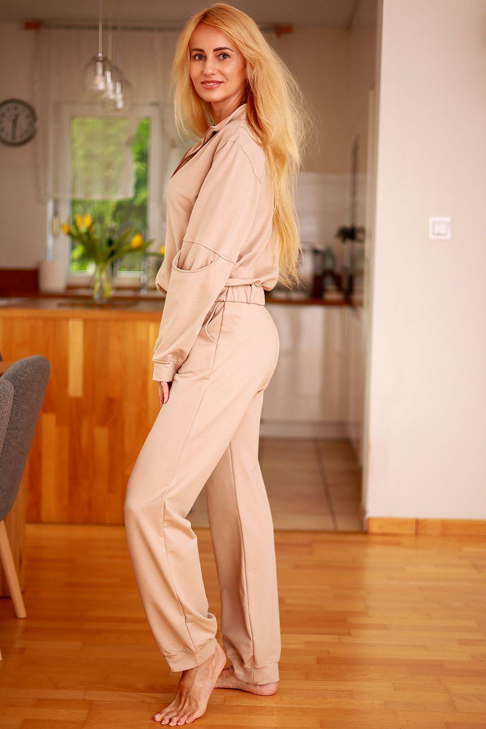 Women’s beige pajama set with zip-front top and drawstring waist pants, side view