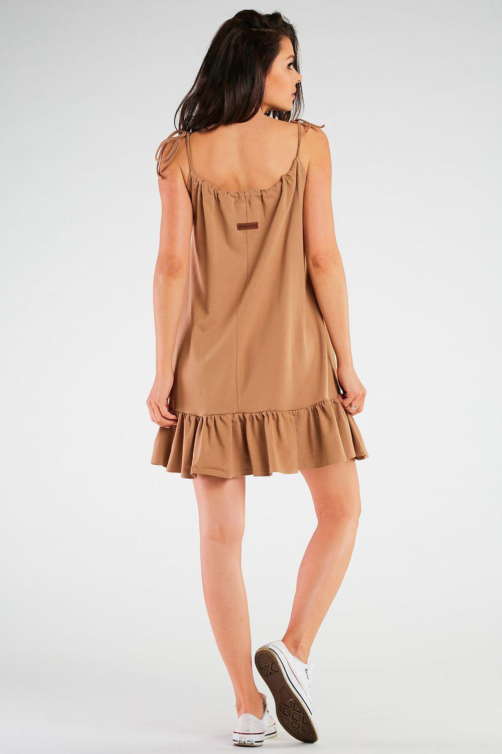 Beige sleeveless daydress from back view with ruffle hem and gathered waist