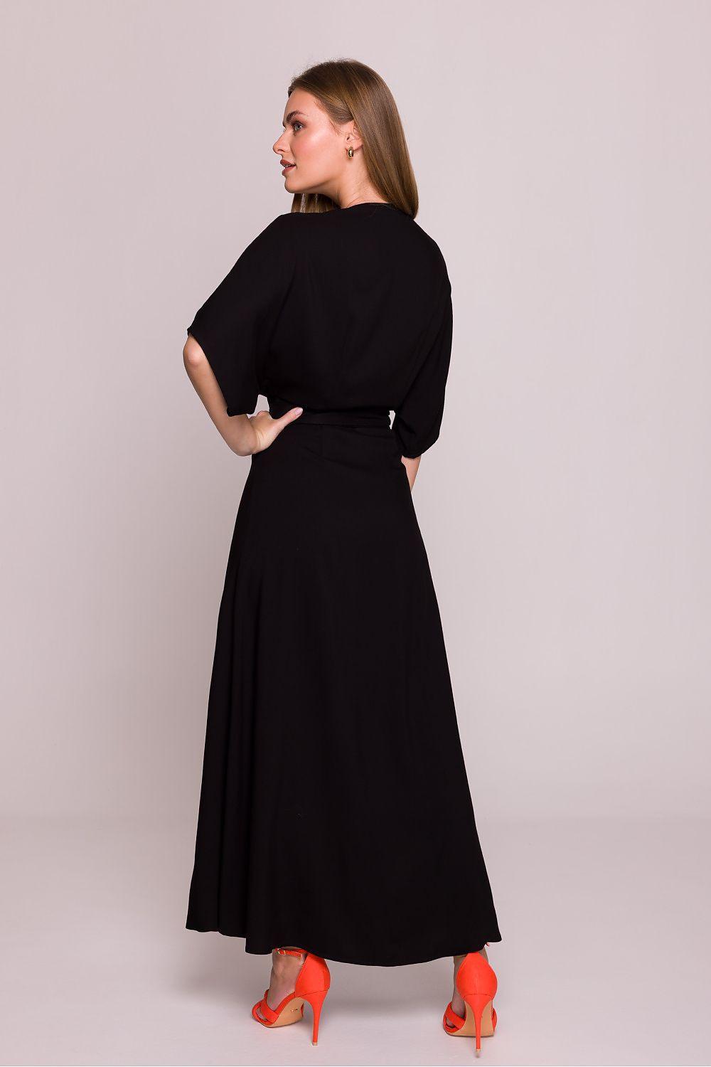 Stylove black V-neck daydress with tied waist belt, back view, flowing midi skirt.