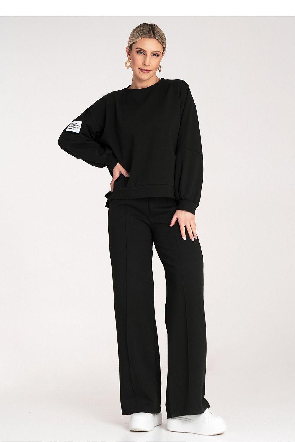 Black tracksuit set with sweatshirt and wide-leg pants, relaxed fit
