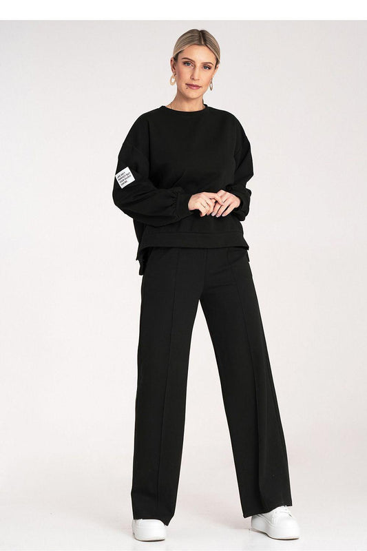 Black two-piece loungewear set with crewneck sweatshirt and relaxed wide-leg trousers