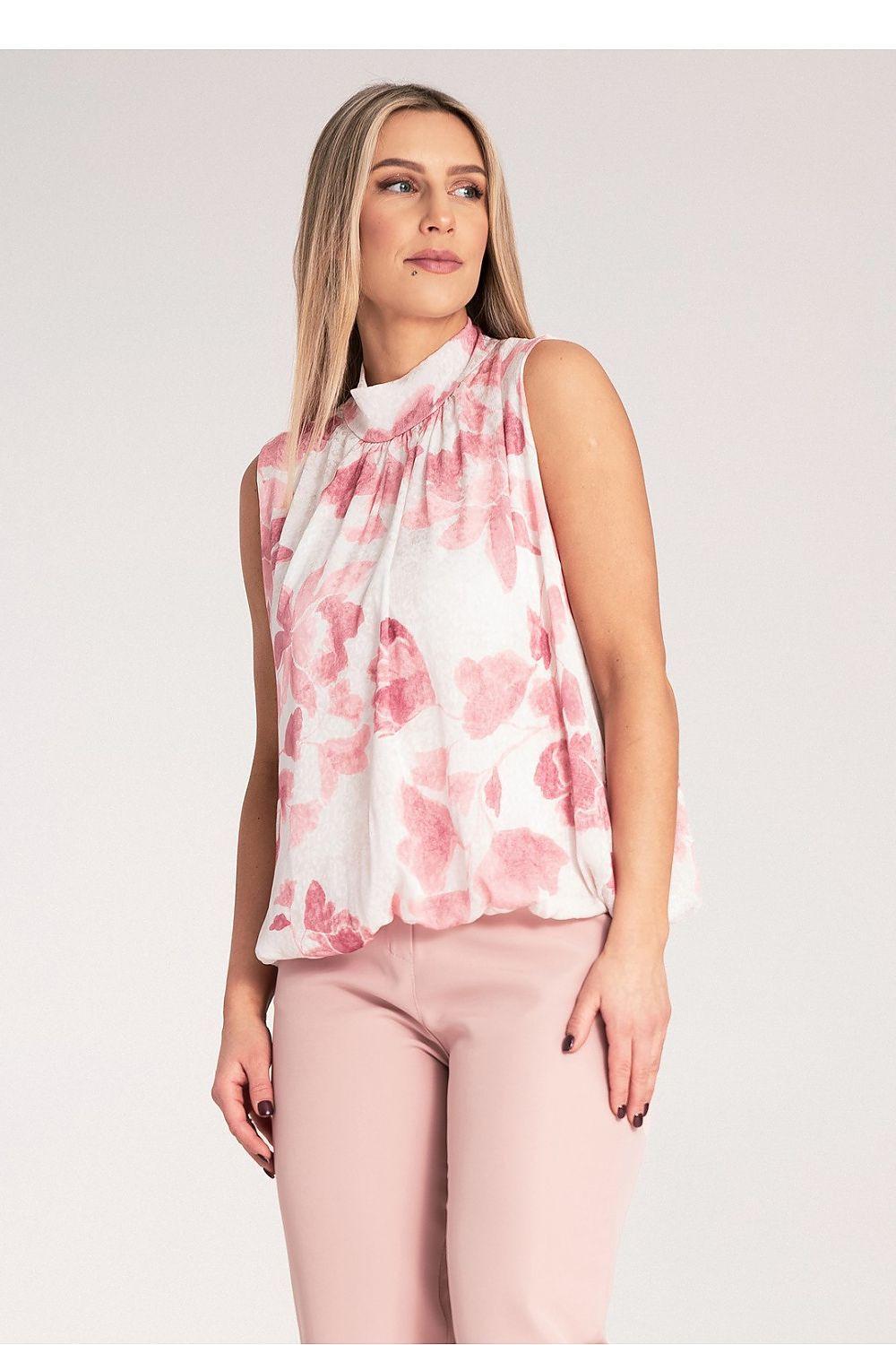 Sleeveless floral blouse, pink print on light fabric, front view with high neckline