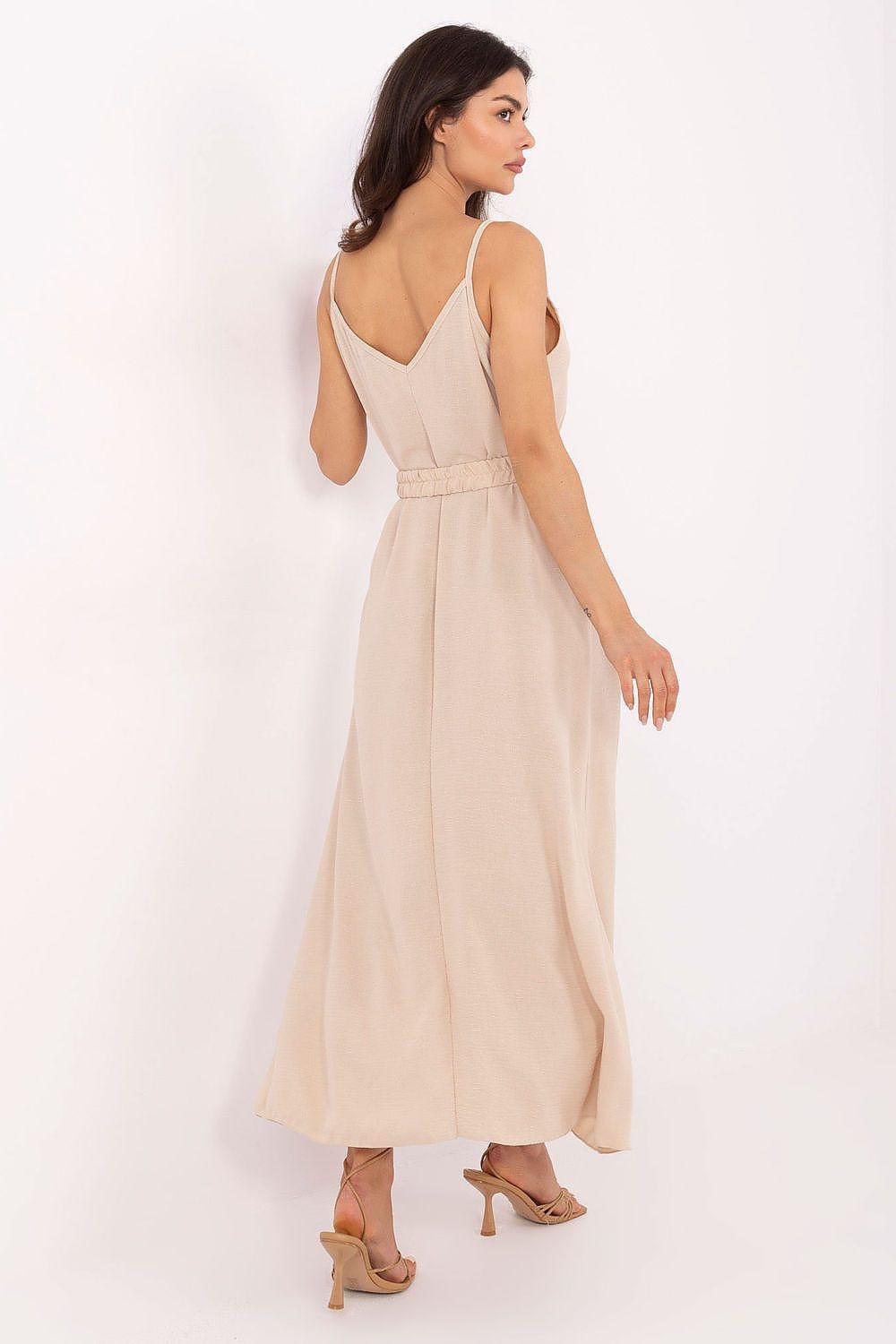 Beige daydress with open back, thin straps, elastic waist belt, and maxi skirt