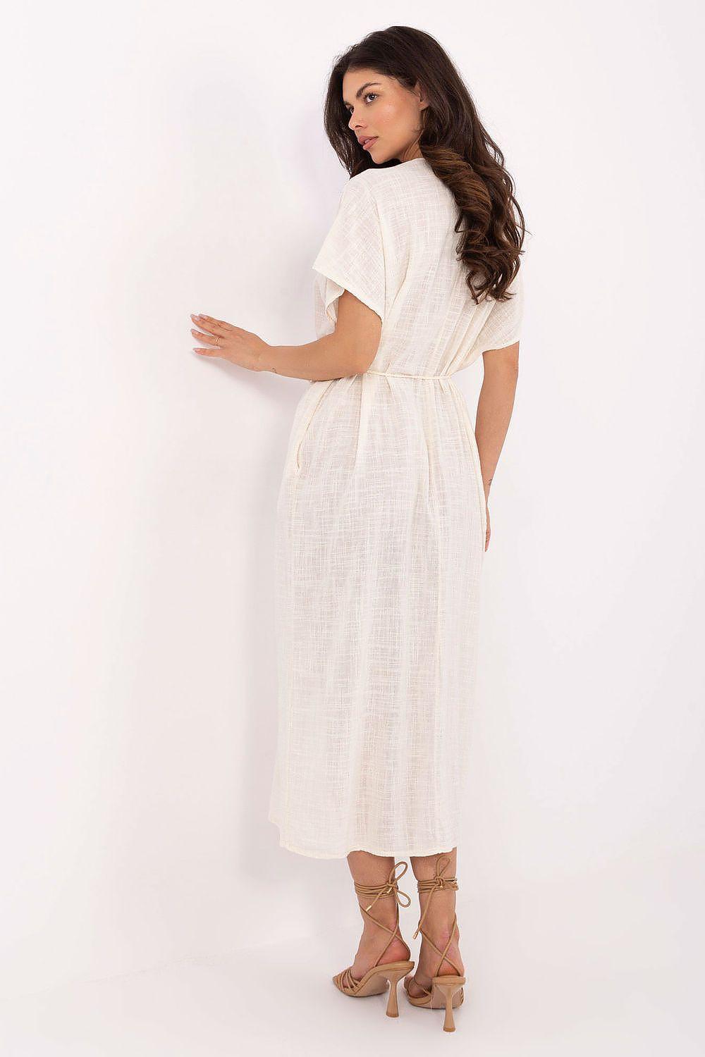 White cotton daydress from back, short sleeves, tie belt, midi length.