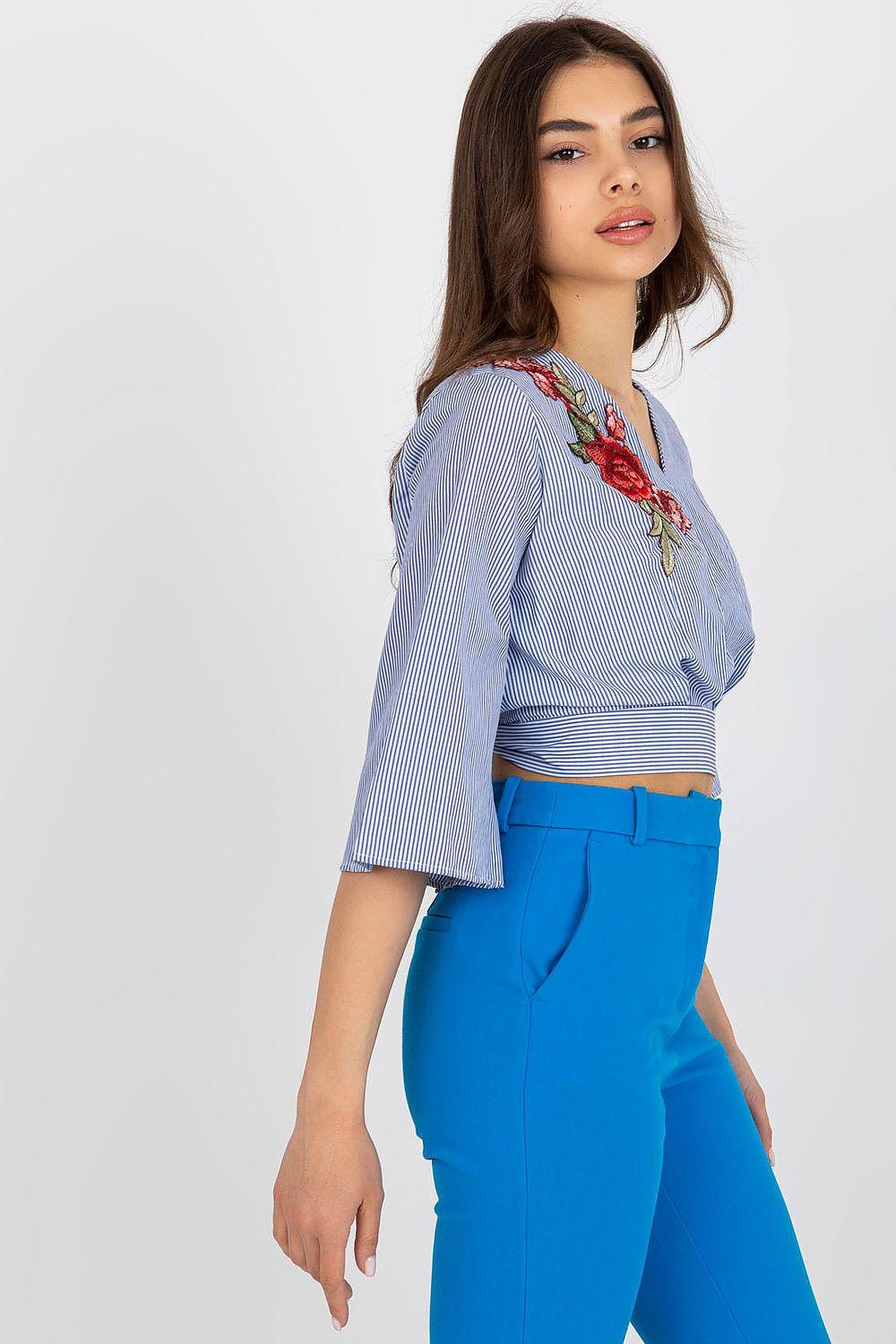 Lakerta blouse side view in light blue stripes with V-neck and red floral embroidery