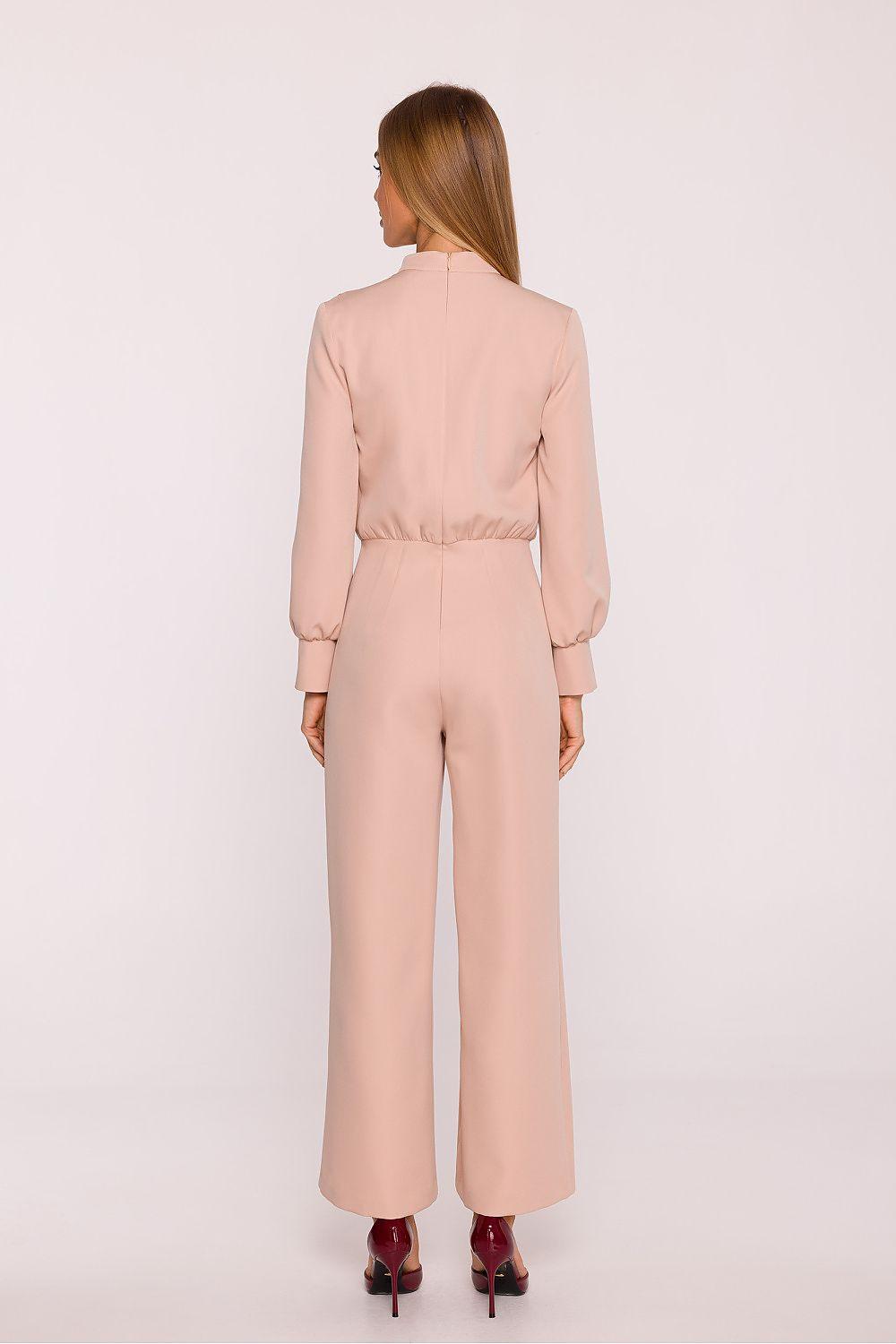 Beige wide-leg jumpsuit from back view with mock neck and long sleeves