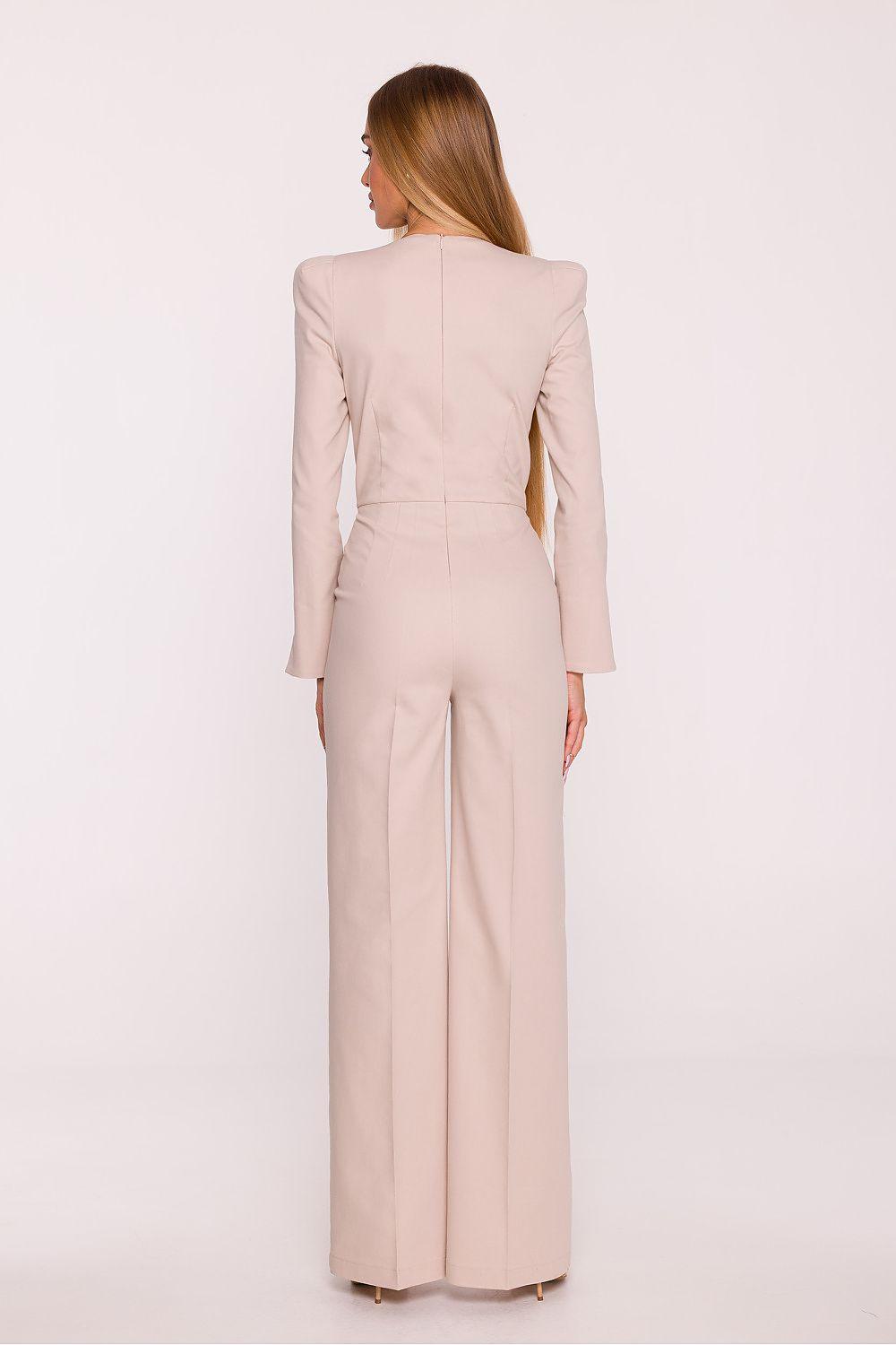 Light beige tailored jumpsuit from back view with long sleeves and wide-leg trousers.