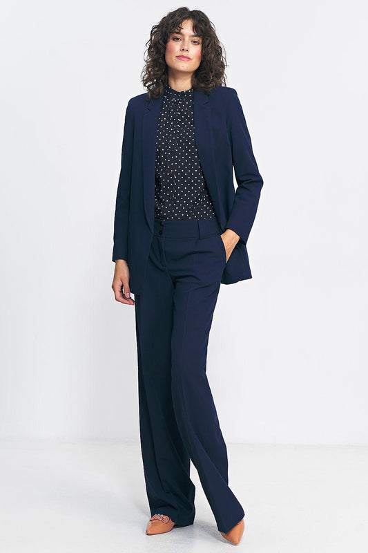 Women’s navy blazer with long sleeves and notched lapels, styled with matching pants