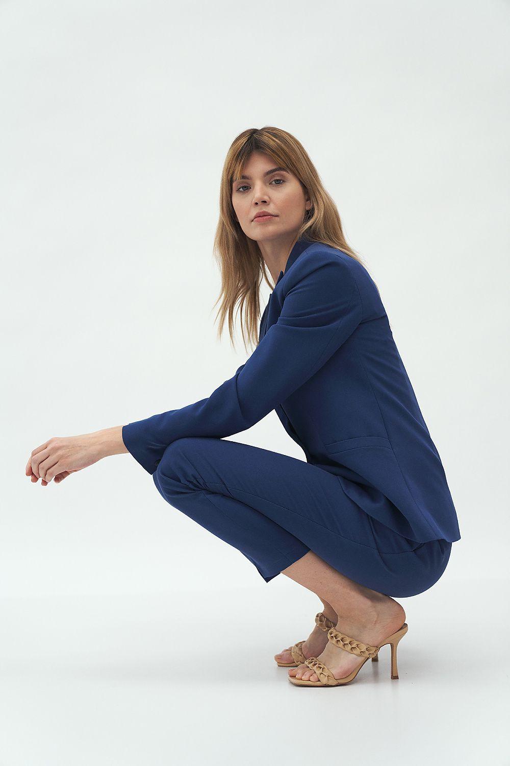 Women's fitted blue blazer and matching pants, side view
