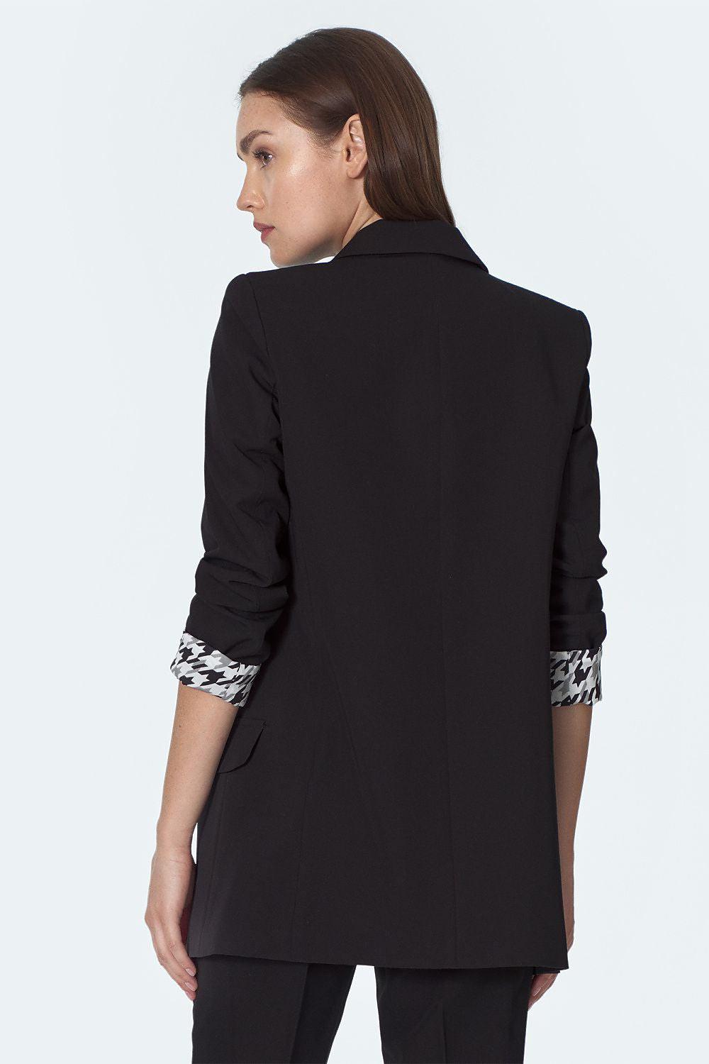 Black women’s blazer back view with patterned cuffs and tailored seams
