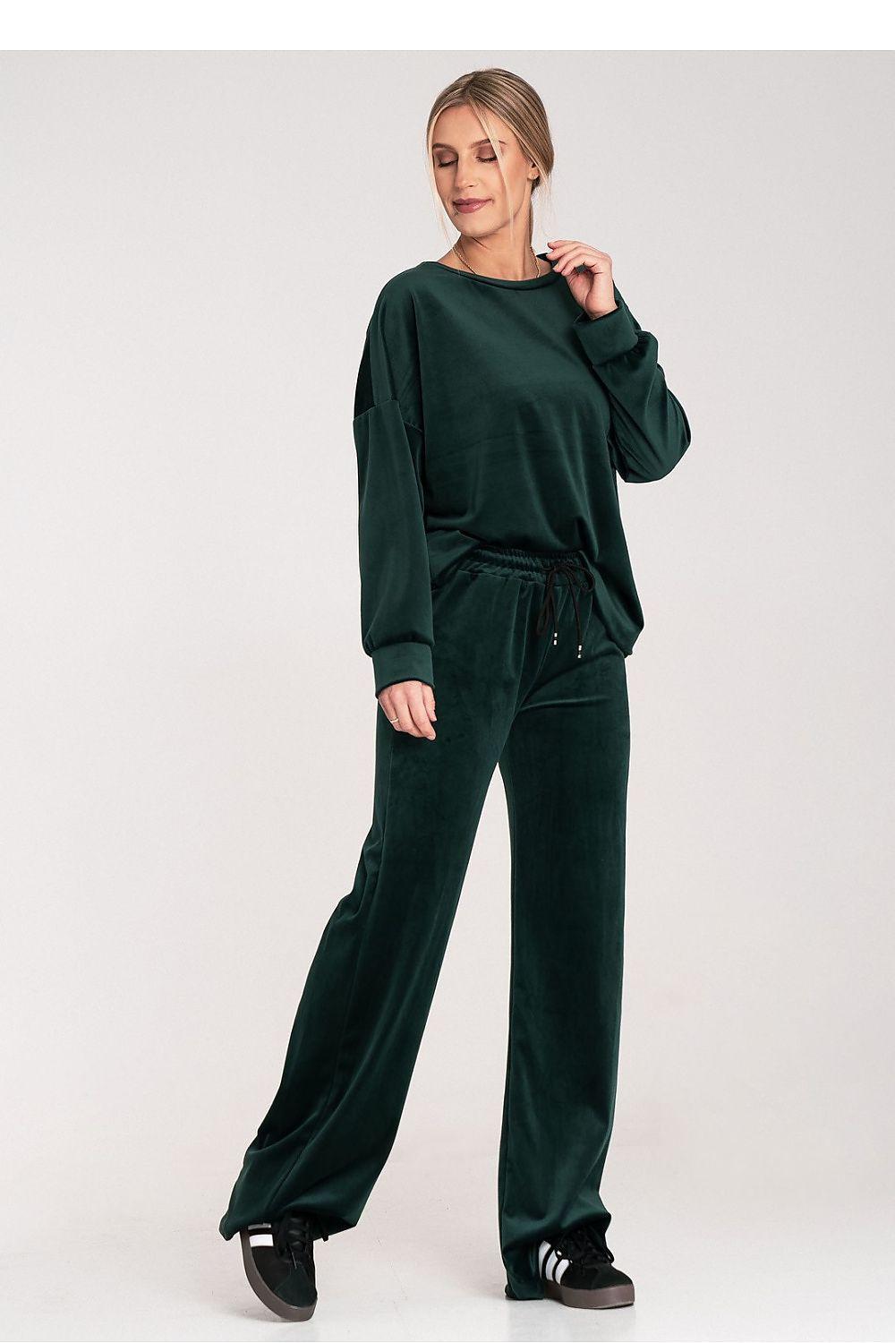 Green velour lounge set with long sleeves, crewneck top, and wide-leg drawstring trousers.