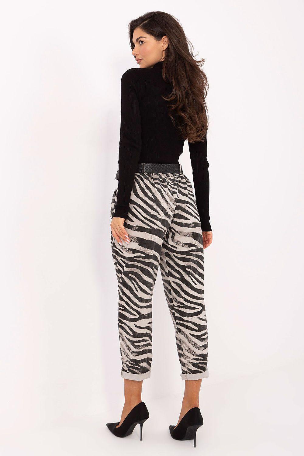 Women’s zebra-print ankle trousers in black and white with dark belt at waist