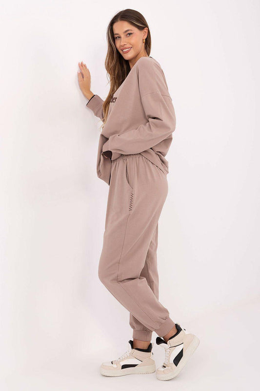 Beige two-piece lounge set with crew-neck sweatshirt and tapered jogger pants