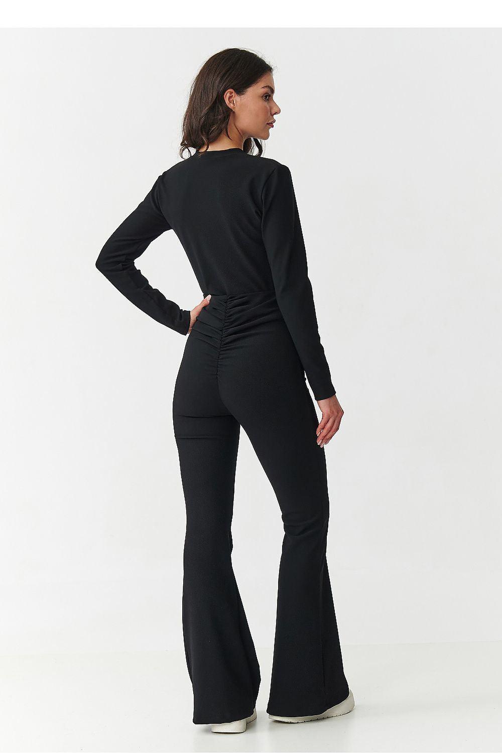 Black two-piece knit set with long sleeves and wide-leg trousers, back view