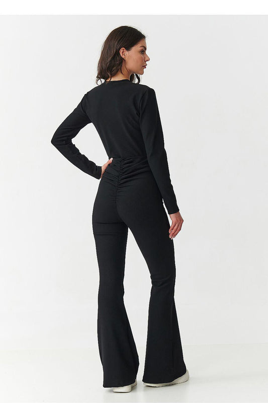 Black two-piece set, back view: long-sleeve top and flared trousers