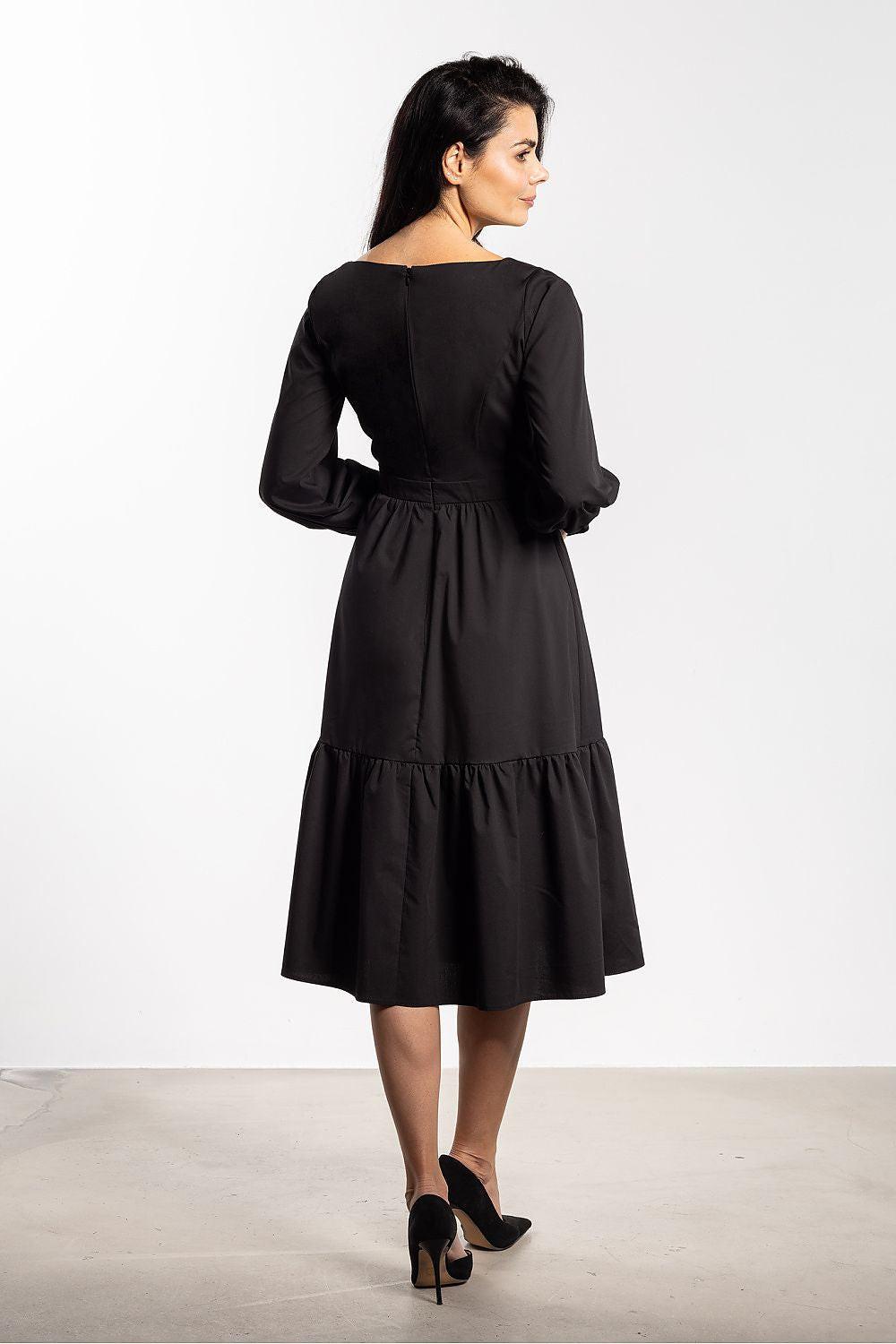 Black daydress back view with long puff sleeves and tiered skirt, gathered waist