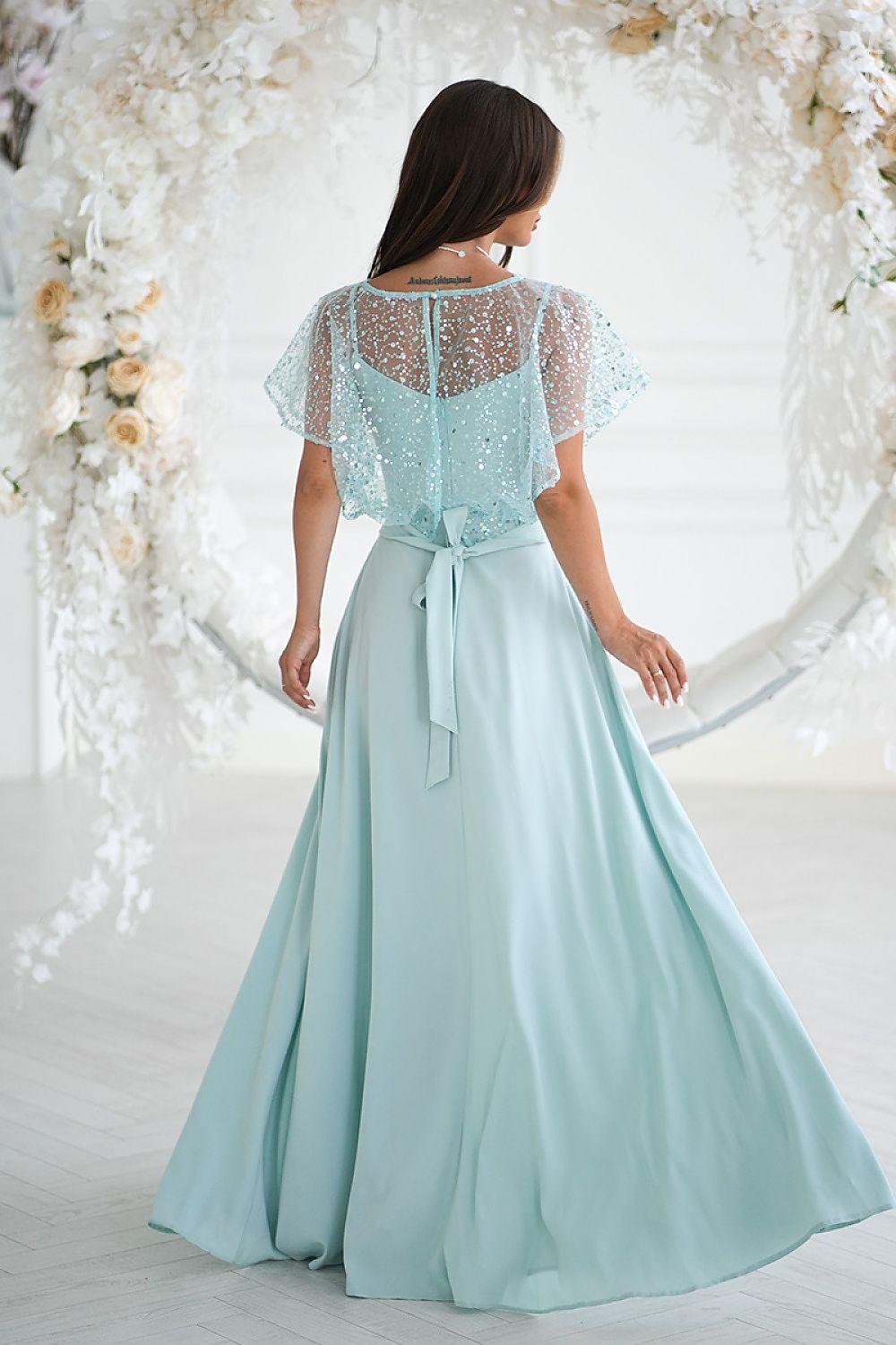 Long light aqua dress back view with sheer sequin sleeves and flowing skirt with slit