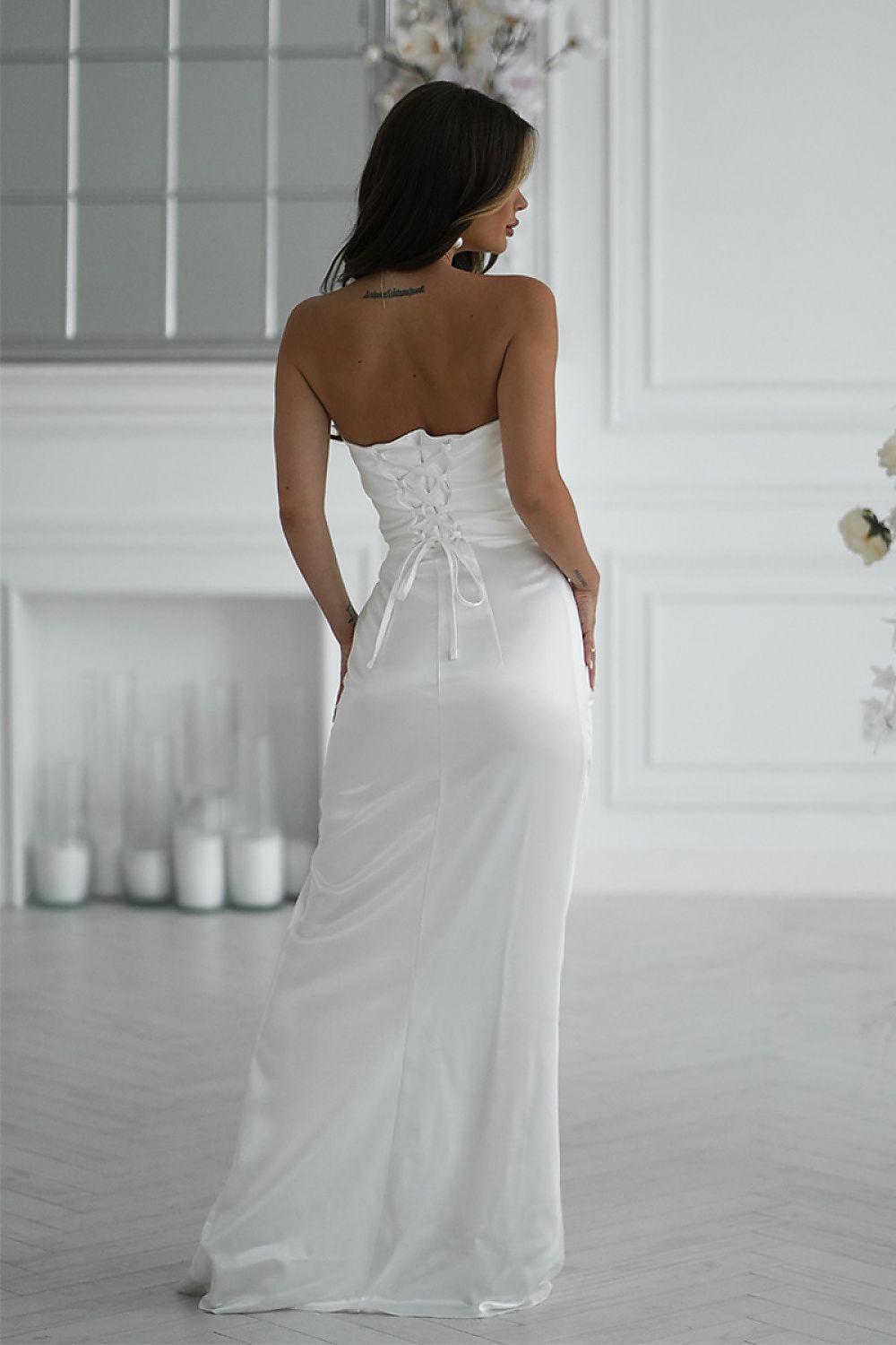 White long backless dress with corset lacing and flowing skirt