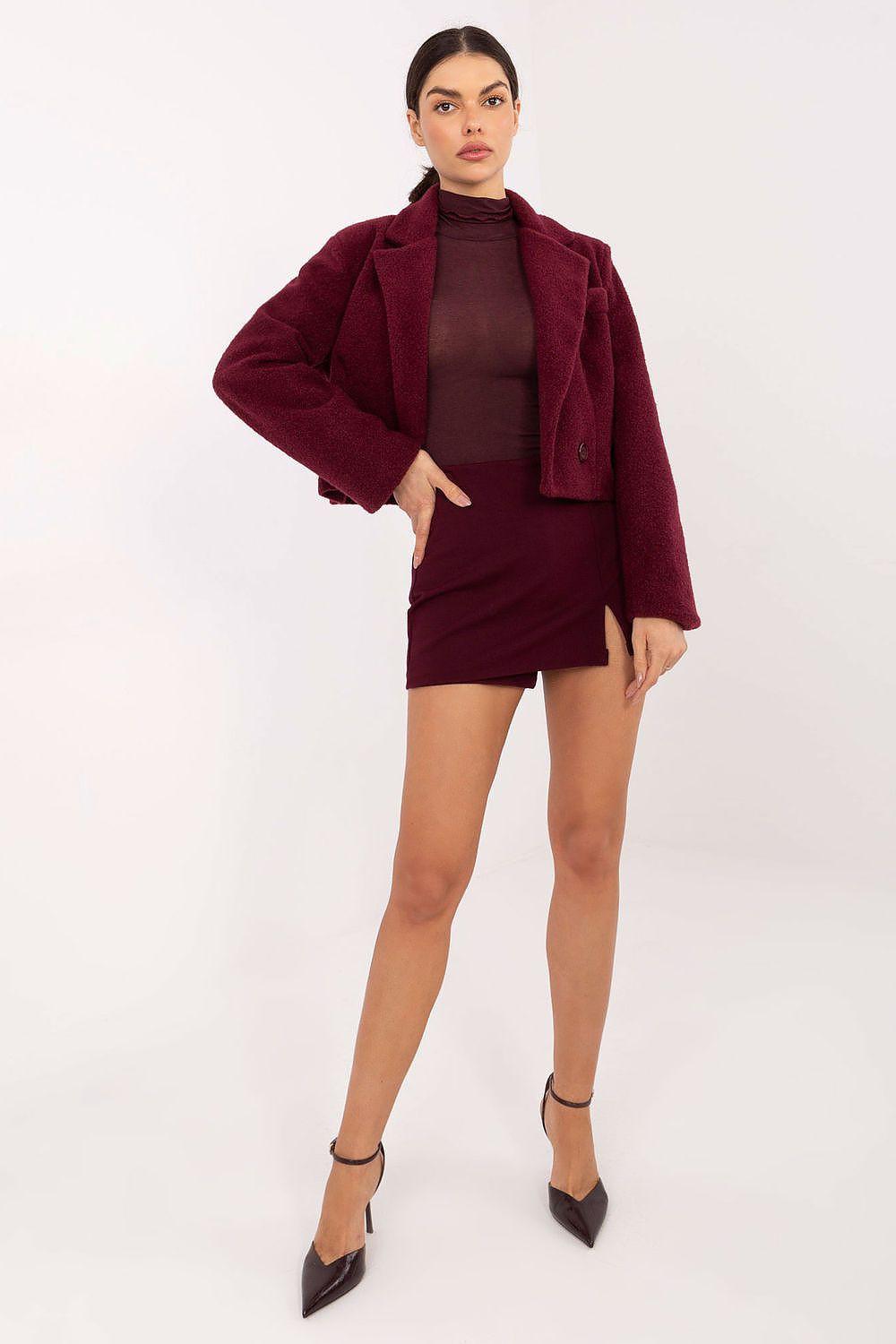 Fitted long-sleeve turtleneck blouse in burgundy under cropped jacket