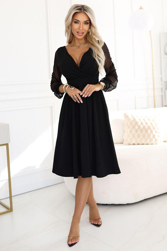 Black V-neck evening dress with sheer long sleeves and flared knee-length skirt