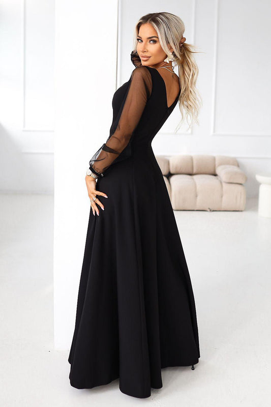 Black maxi dress with sheer tulle sleeves, side view, V-neck and flowing A-line skirt