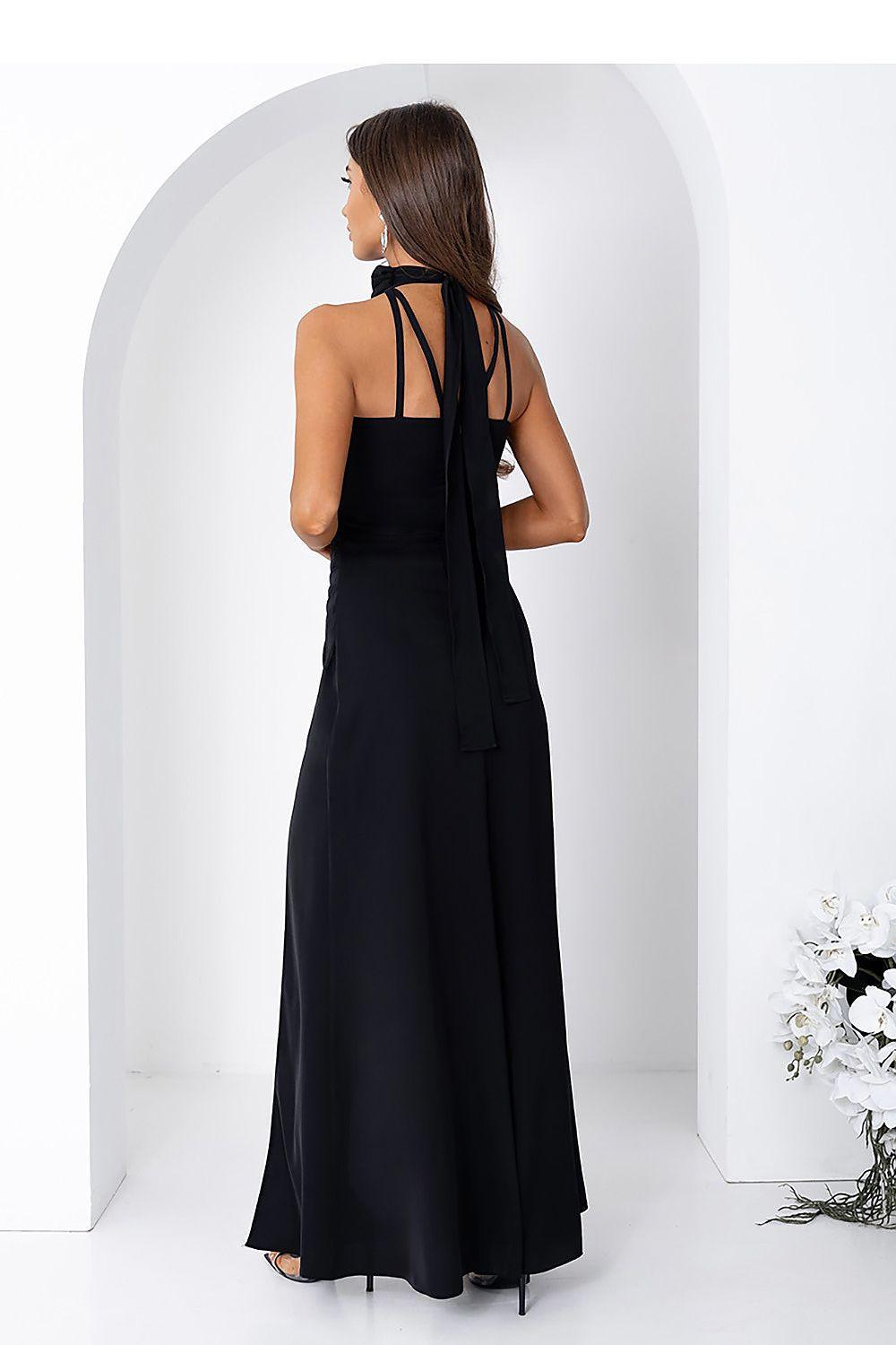 Black sleeveless maxi dress with open-back straps and high slit; long flowing back view.