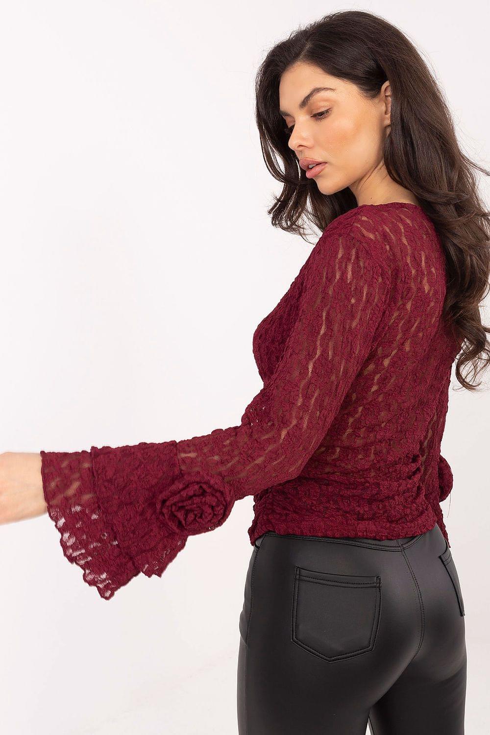 Red lace blouse with long flared sleeves and lace cuff detail, side view.