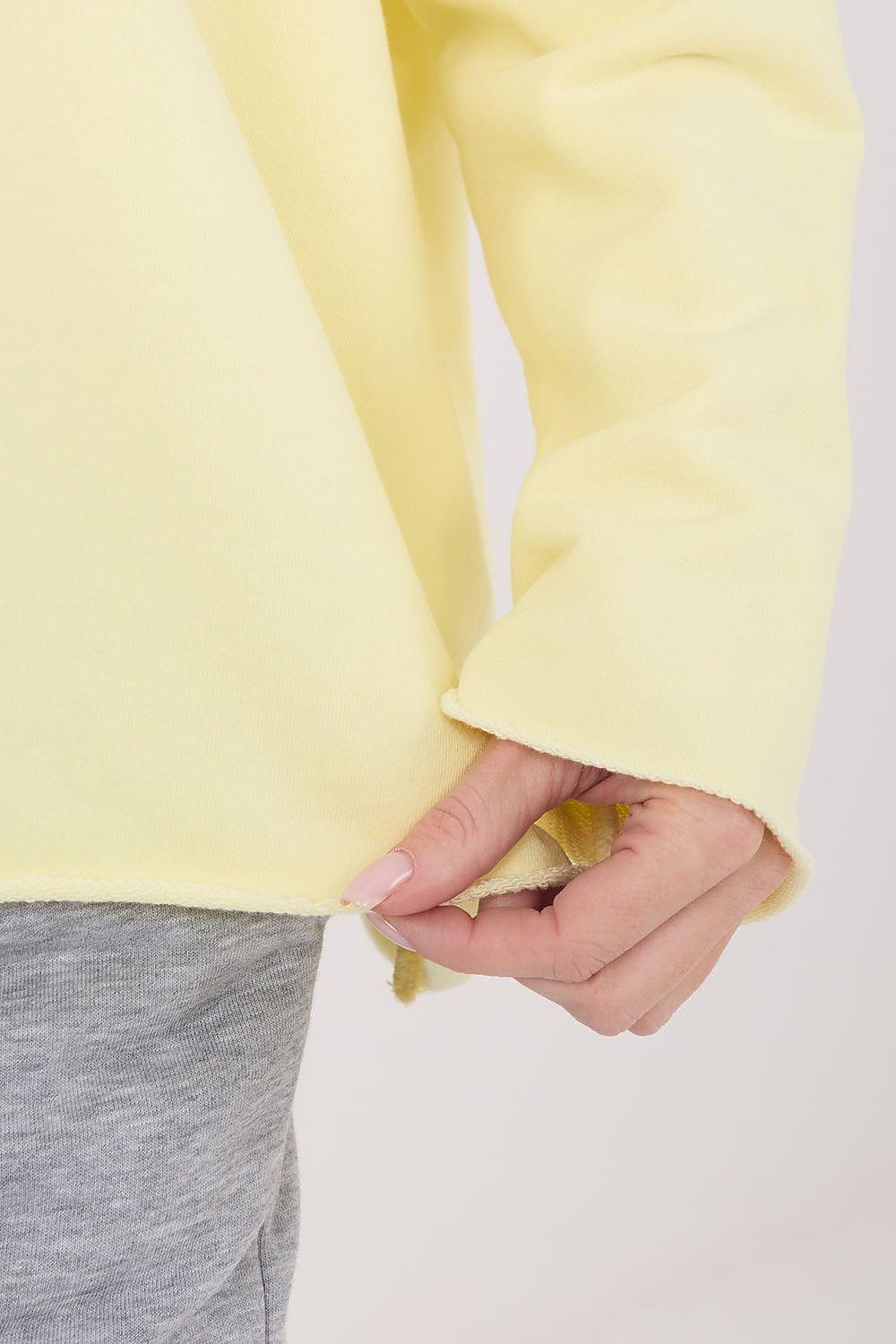 Yellow blouse sleeve cuff detail with stitched hem
