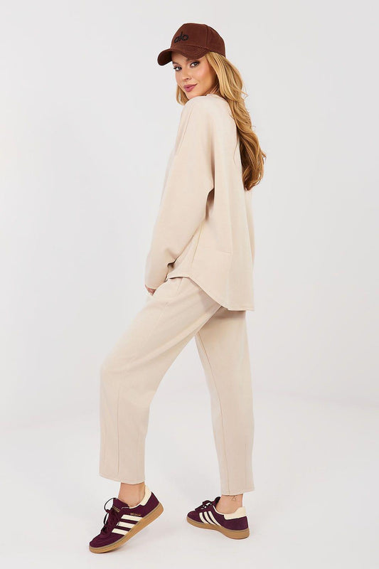 Beige two-piece lounge set with long-sleeve top and straight-leg cropped pants, side view