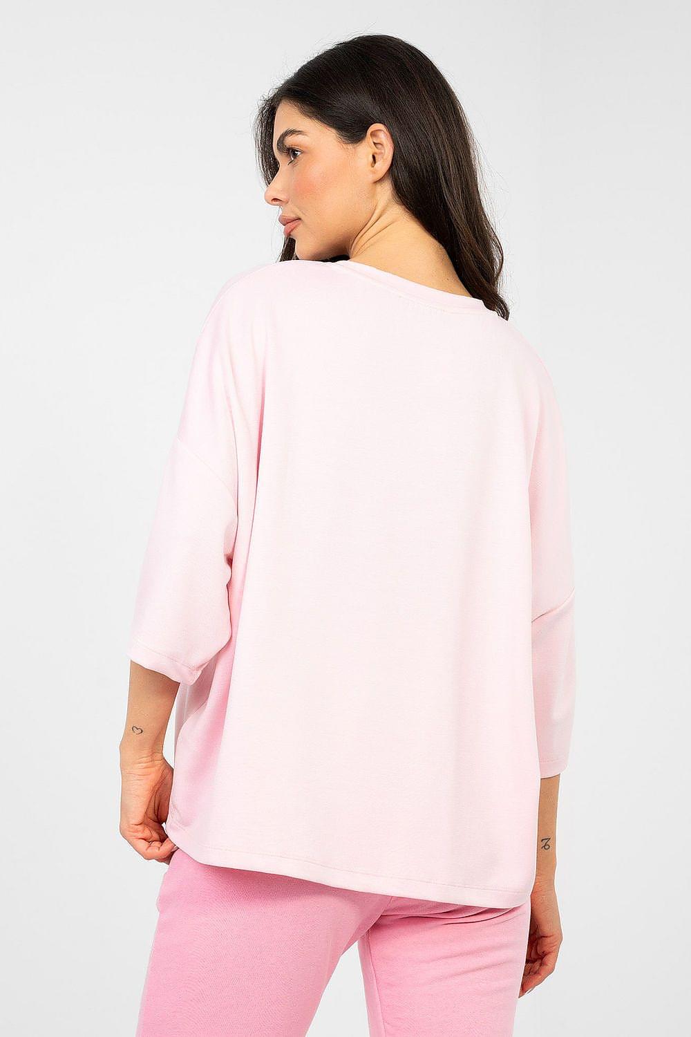 Pink blouse back view with wide sleeves and relaxed drape