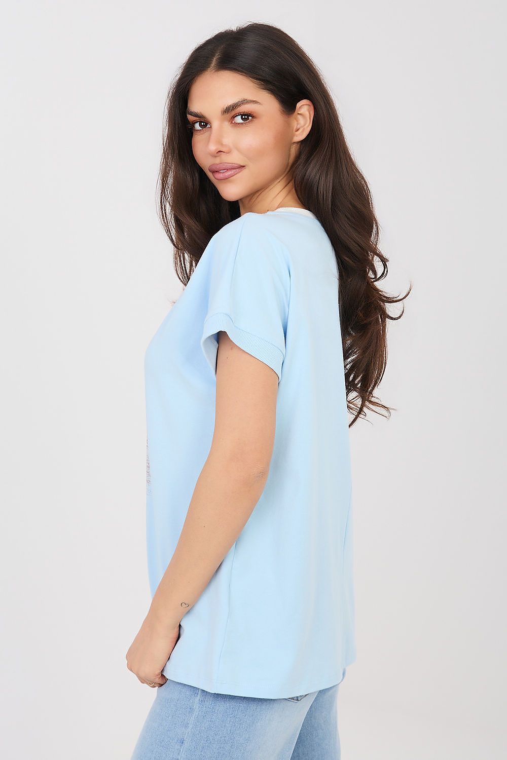 Light blue short-sleeve blouse with crew neckline, side profile