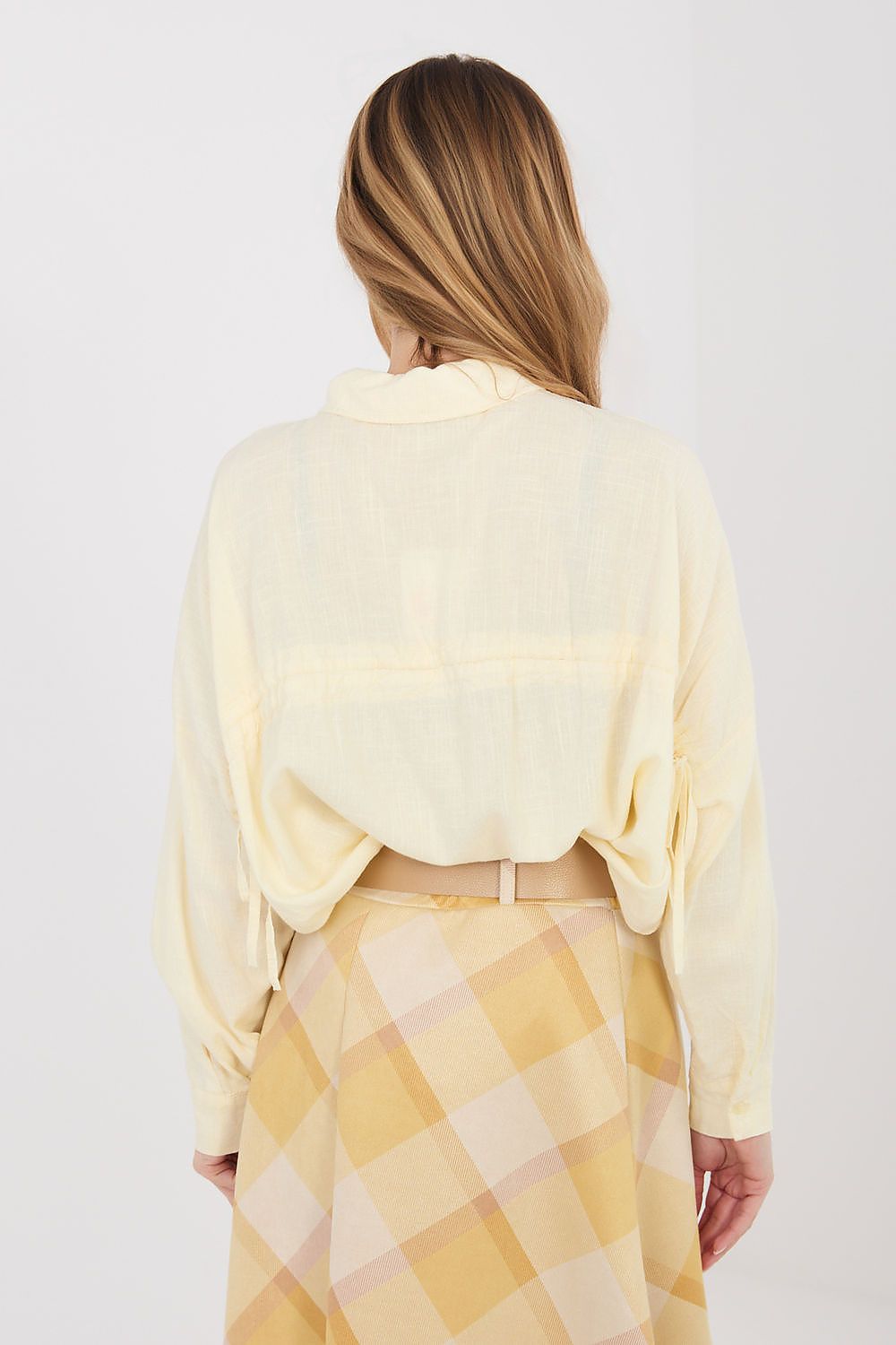 Light yellow long-sleeve shirt back view with tied cuff details and full button placket