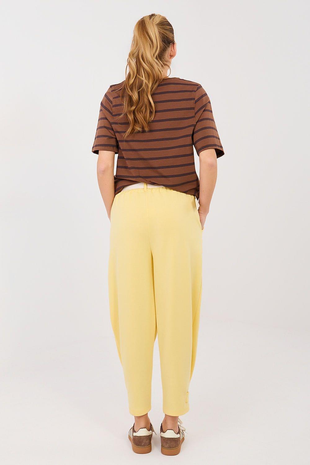 Yellow tracksuit trousers with cuffed hems and gathered drawstring waist, rear view