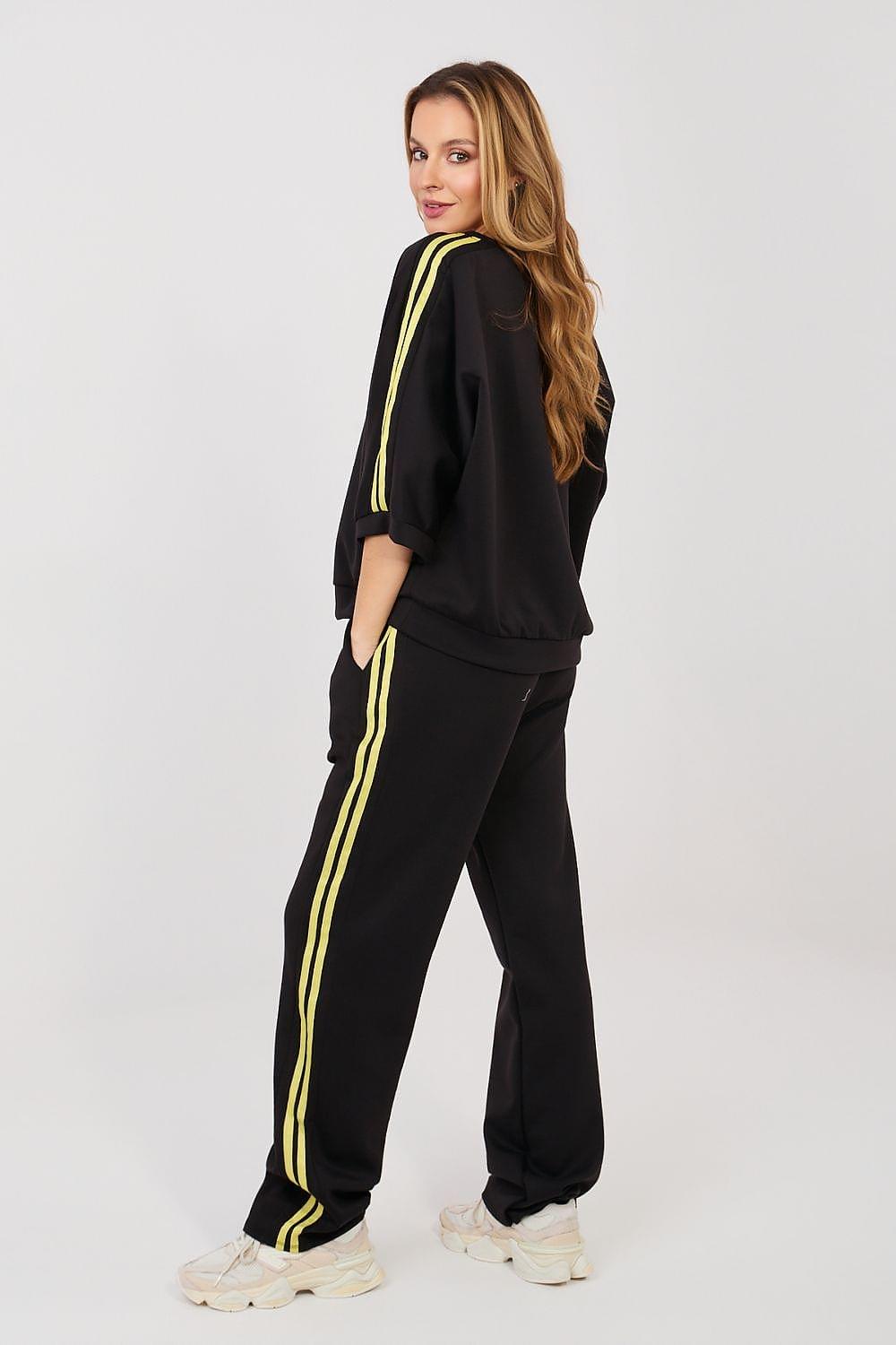 Black two-piece tracksuit set with neon yellow stripe down pant leg and sleeve