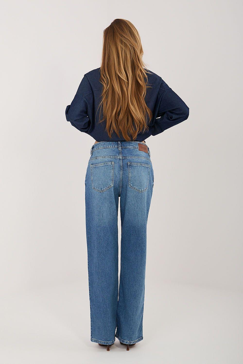 Back view of blue denim jeans with wide legs, yoke stitching and back pockets