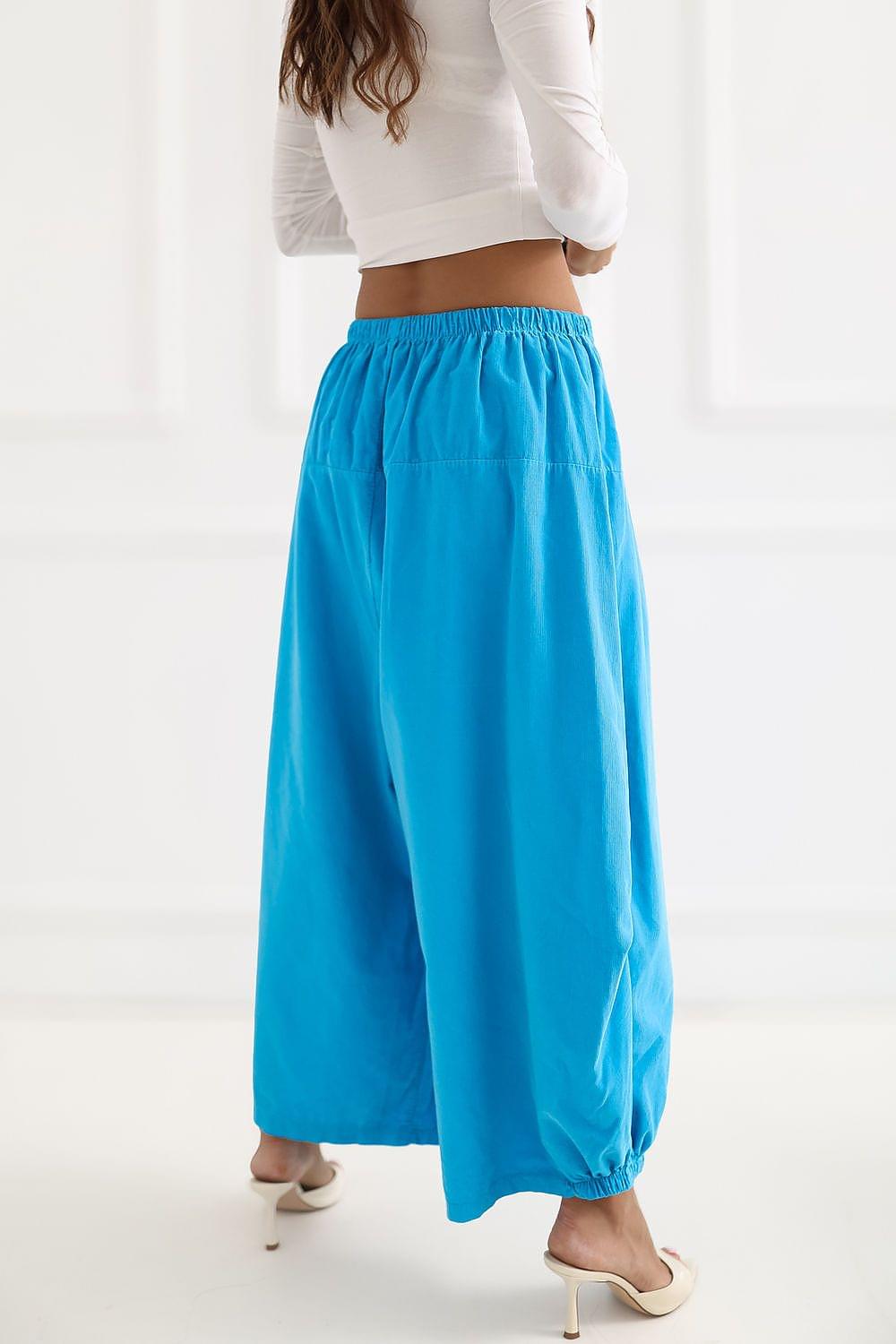 Blue wide-leg trousers with elastic waistband and draped back, ankle-length