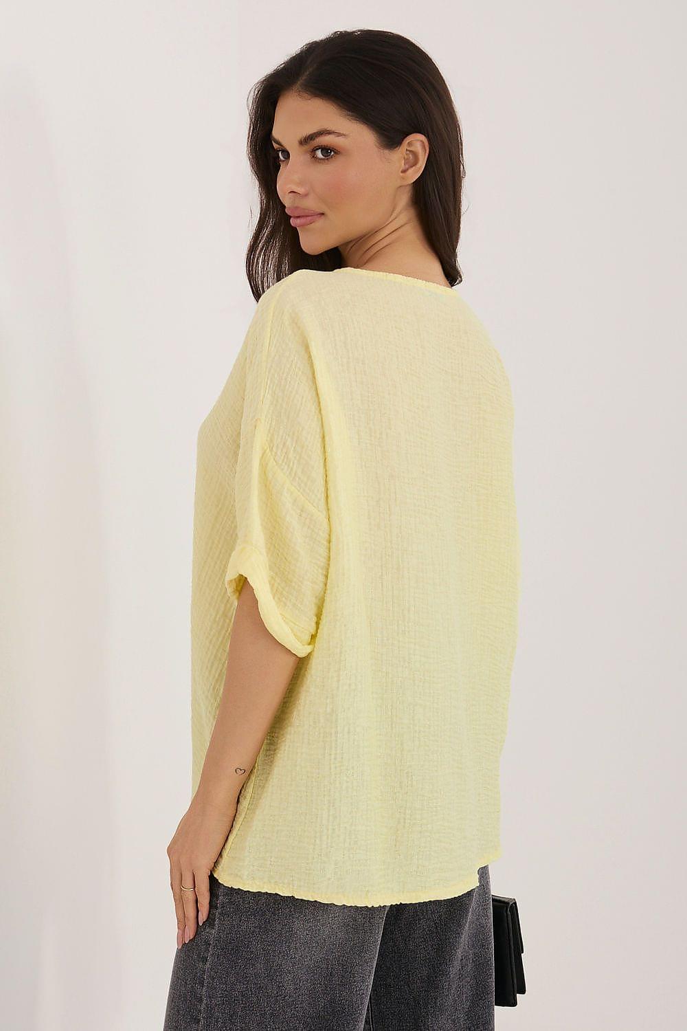 Light yellow short-sleeve shirt with curved back hem, back view