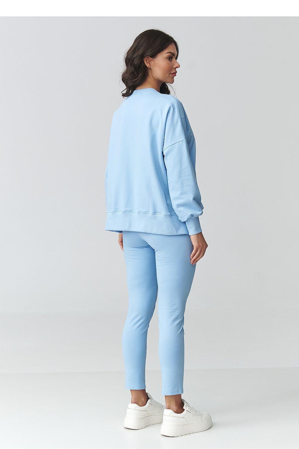 Women’s lounge set: light blue sweatshirt and slim trousers, side view